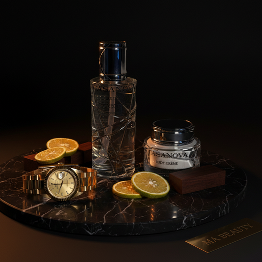 Bottle of Casanova Body Oil, jar of Casanova body crème, watch, and sliced oranges on a dark marble tray.
