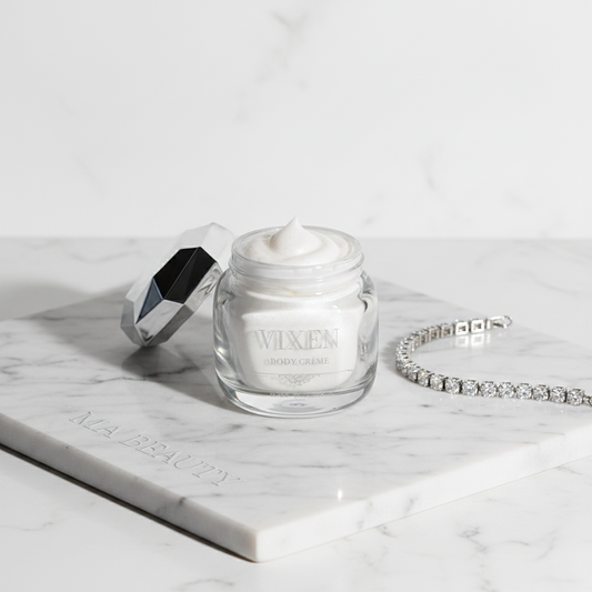 VIXEN cream jar with a silver spoon and bracelet on a marble surface